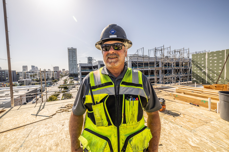 JPI team member on top of building under construction